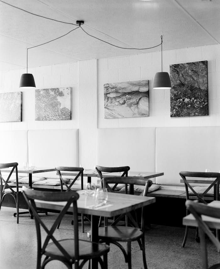 Classic black and white photo of an elegant restaurant interior with stylish seating.
